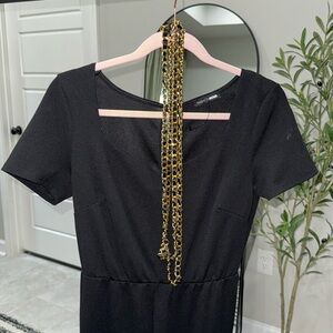 Stacked leg black jumpsuit with gold belt